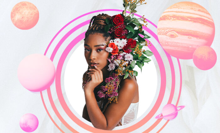 A woman with flowers in her hair is surrounded by orange and purple planets.