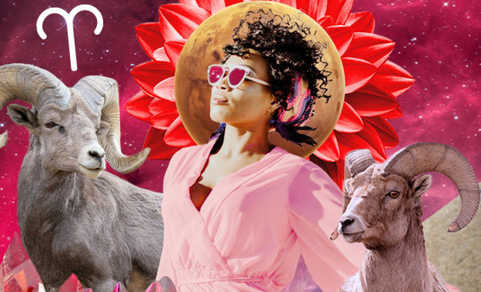 A woman in sunglasses looks into the sunlight, flanked by two rams, representing Aries.
